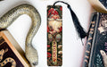 a bookmark with a snake and a book on it