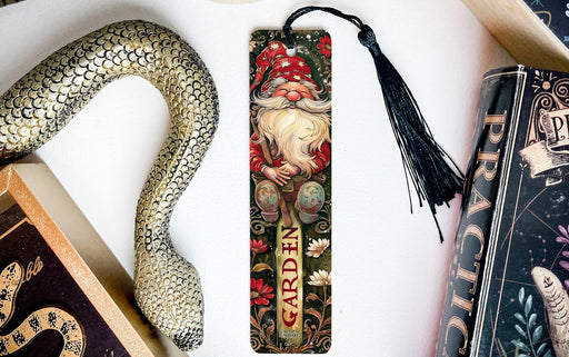 a bookmark with a snake and a book on it