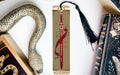 a bookmark with a snake on it next to other books