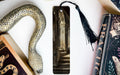 a snake, books, and a bookmark on a table