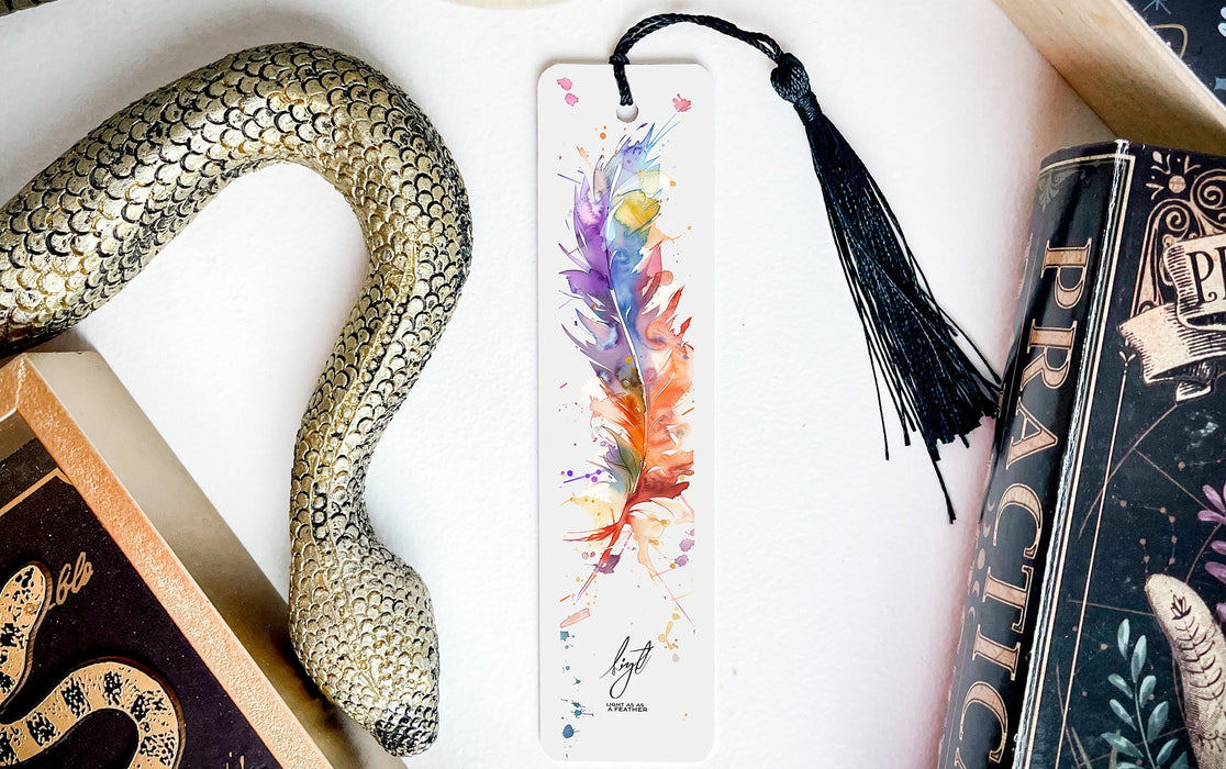 a bookmark with a feather and a snake on it