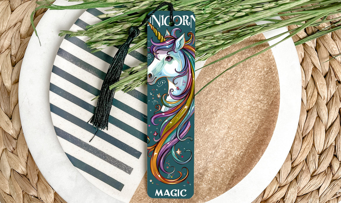 a bookmark with a unicorn on it sitting on a plate