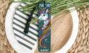 a bookmark with a unicorn on it sitting on a plate