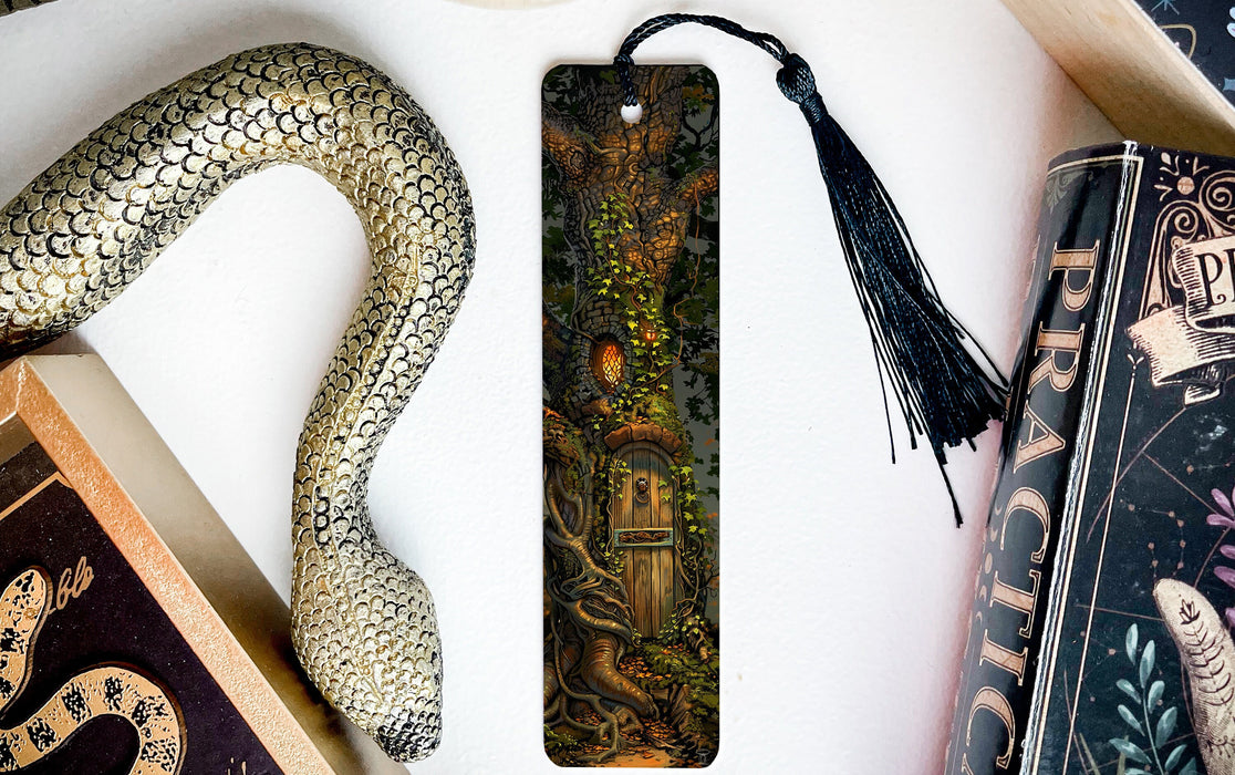 a bookmark with a snake on it next to books