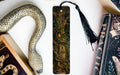 a bookmark with a snake on it next to books