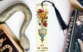 a bookmark with a picture of a vase and a snake