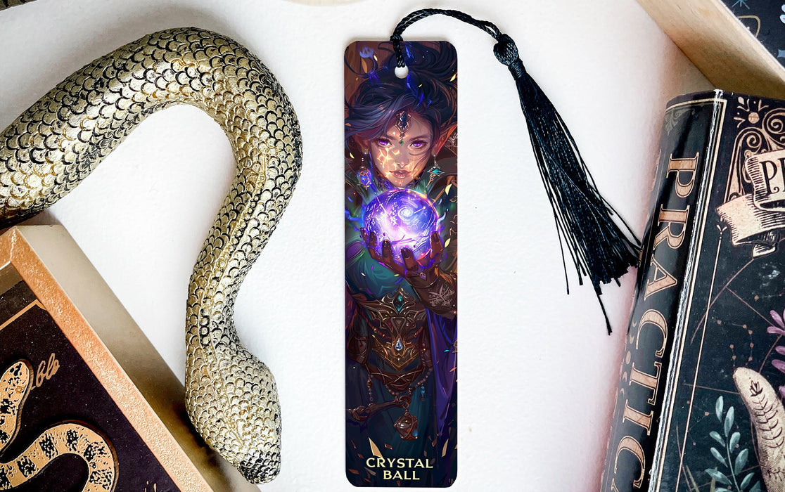 a bookmark with a picture of a woman holding a crystal ball