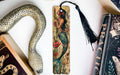 a bookmark with a mermaid on it next to books