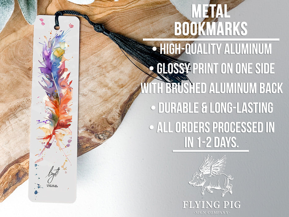 a metal bookmark with a feather on it
