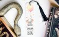 a bookmark with an elephant and a balloon on it