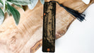 a piece of wood with a tassel on top of it