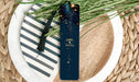 a blue bookmark sitting on top of a white plate