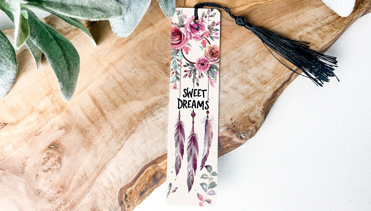 a bookmark with flowers and feathers on it