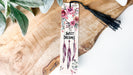 a bookmark with flowers and feathers on it