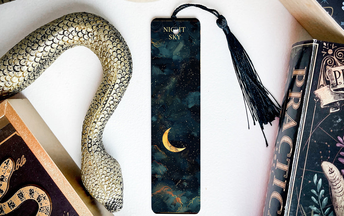a bookmark with a snake on it next to other books