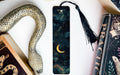 a bookmark with a snake on it next to other books