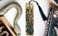 a bookmark with a snake and a book on it
