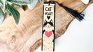 a bookmark with a picture of a cat with a heart on it