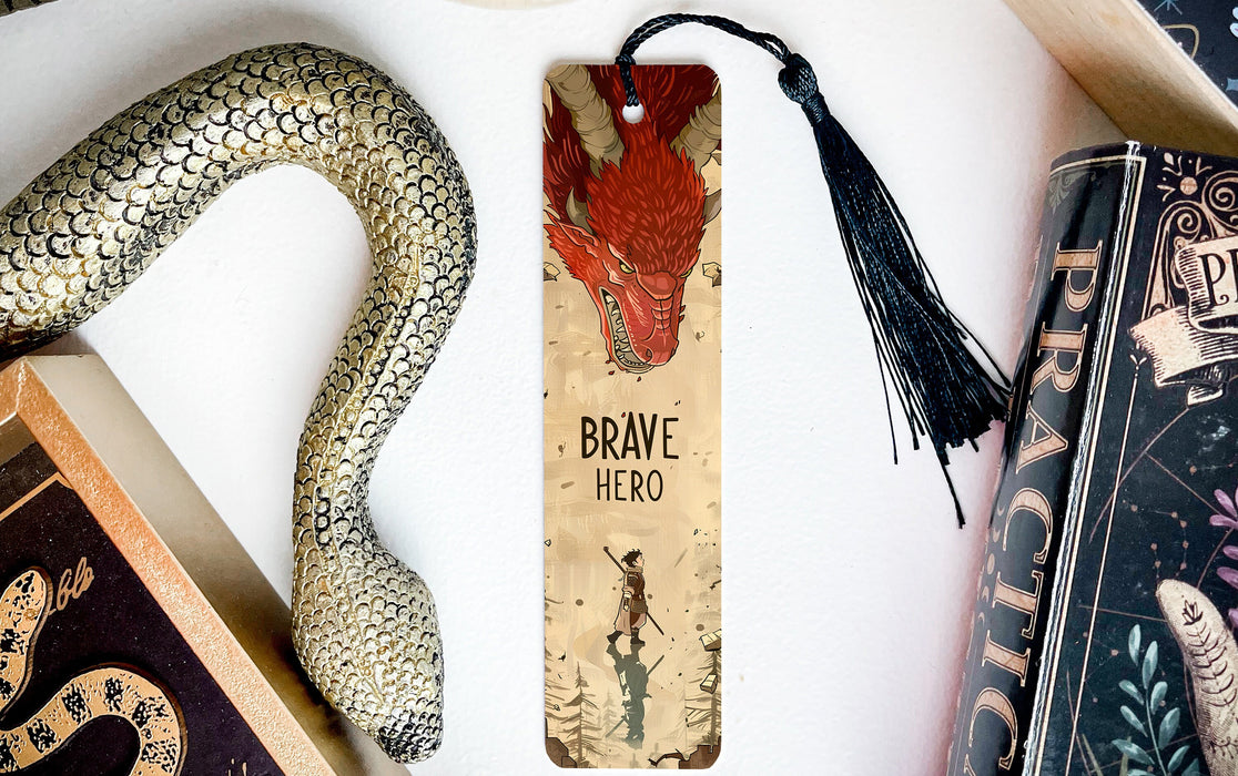a bookmark with a snake on it next to books