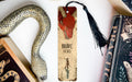 a bookmark with a snake on it next to books