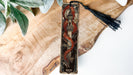 a piece of wood with a tassel on top of it