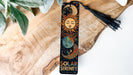 a bookmark with a sun and a moon on it
