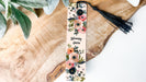 a bookmark with a floral design and a tassel