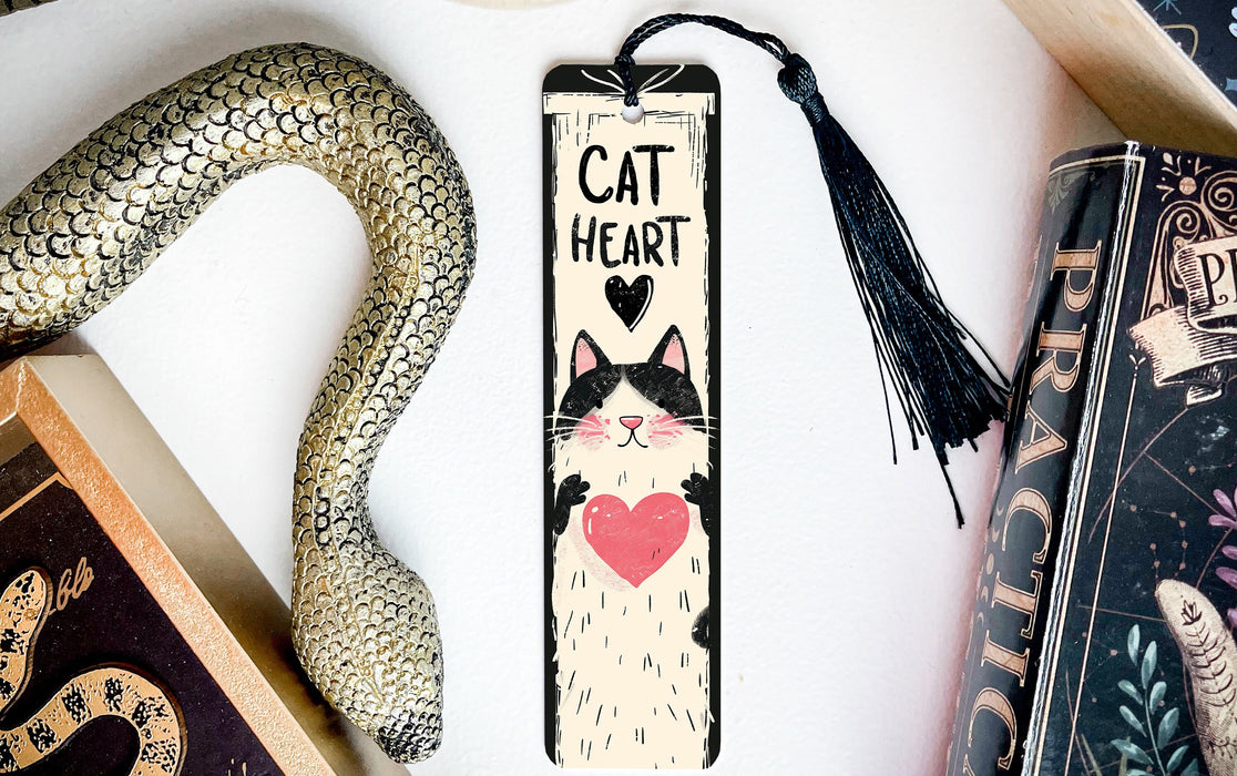 a bookmark with a cat on it next to a snake