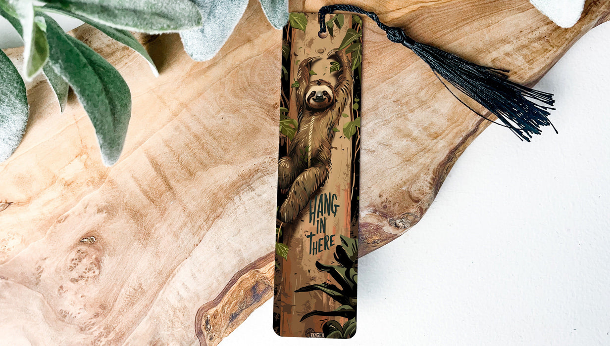 a bookmark with a bear on it and a tassel hanging from it