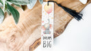 a bookmark with a picture of an elephant holding a balloon