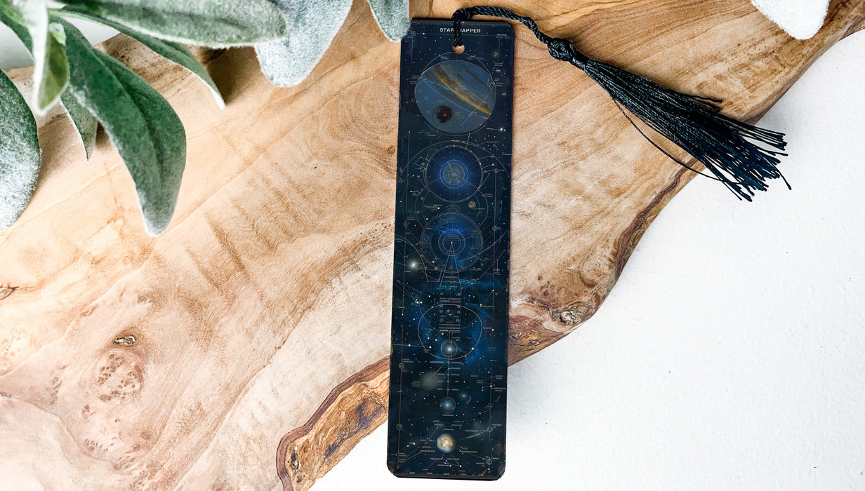 a wooden board with a tassel on top of it