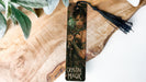 a bookmark with a picture of a woman holding a knife