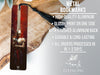 a metal bookmark with a red cover and a black tassel