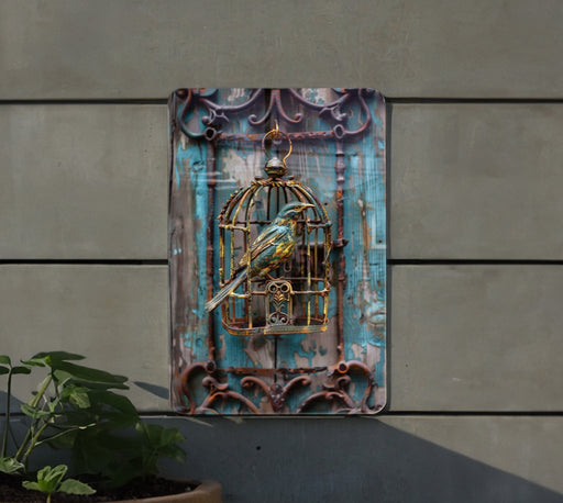 a bird in a cage hanging on the side of a building