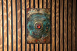 a metal plate mounted to a wooden wall