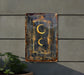 a metal sign hanging on the side of a building