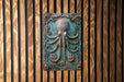 a metal plaque with an octopus on it