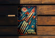 a book with a rocket on it sitting on a bench