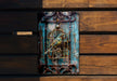 a bird in a cage on a wooden wall