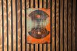 a sign on a wooden wall that has a design on it