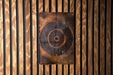 a wall mounted fan mounted to a wooden wall
