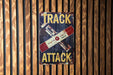 a sign on a wooden wall that says track attack