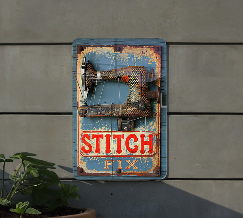 a sign that says stitch next to a potted plant