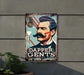 a metal sign with a picture of a man with a mustache