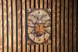 a metal bug on a wooden wall