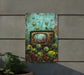 a painting on a wall of plants and a tv
