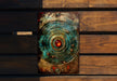 a piece of metal sitting on top of a wooden bench