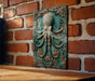a wooden table topped with a metal octopus plaque