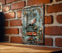 a picture of a bird in a cage on a brick wall