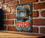 a picture of a stitch fix sign on a brick wall